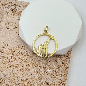 A sterling silver gold-plated giraffe pendant with multiple zirconia stones set in a circle design.