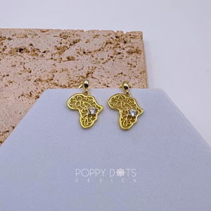 A pair of sterling silver earrings with gold plating and zirconia stones, designed in the shape of the African continent, displayed against a neutral background.