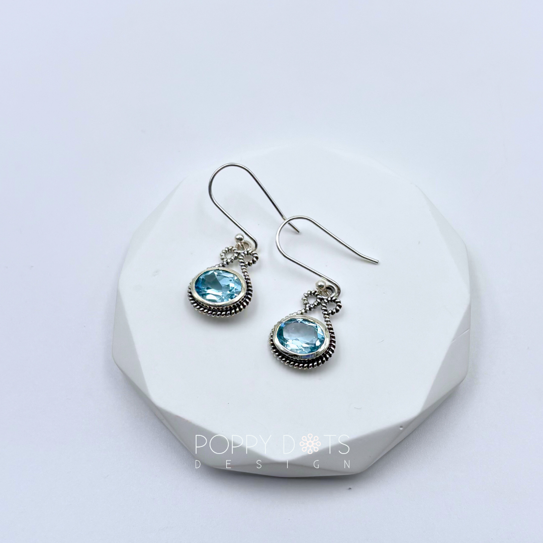Sterling Silver Bow Blue Topaz Oval Earrings