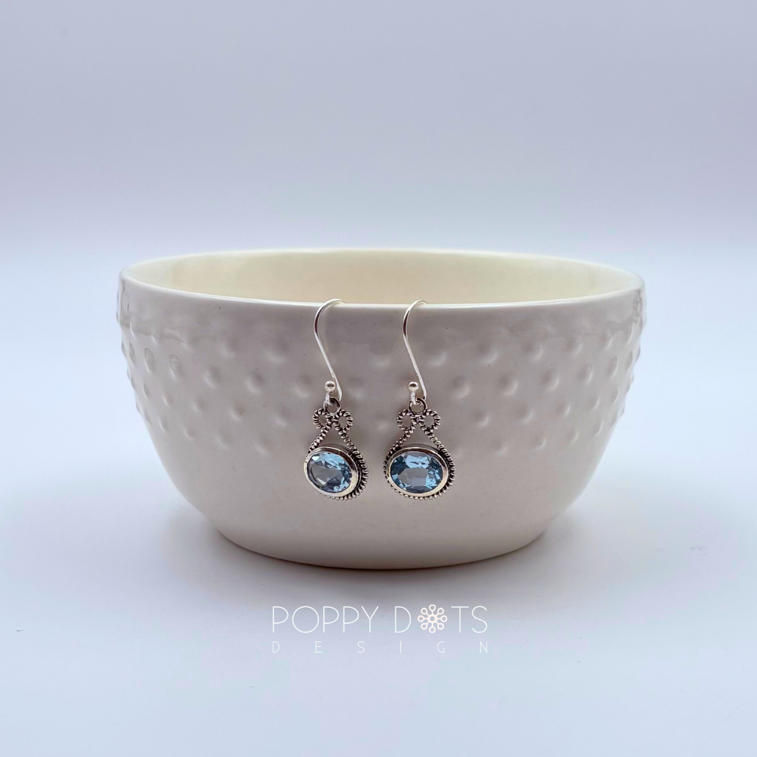 Sterling Silver Bow Blue Topaz Oval Earrings