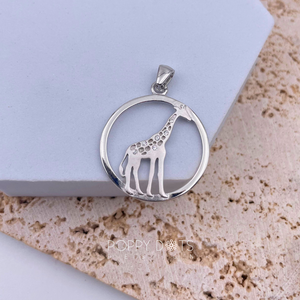 A sterling silver pendant in the shape of a giraffe with zirconia stones, displayed against a light background.