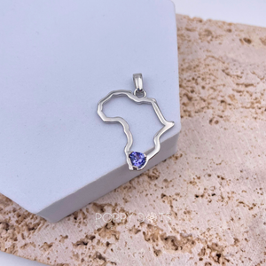 Sterling silver pendant in the shape of Africa with a trillion cut Tanzanite gemstone set in the center, displayed against a neutral background.